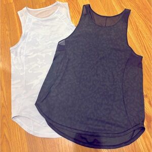 Two lululemon sculpt tanks size 4. Black camo and white and gray camo